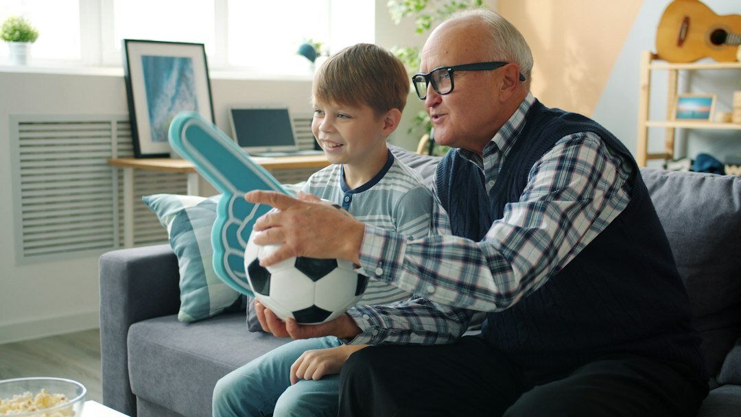 Family watching television together in a living room