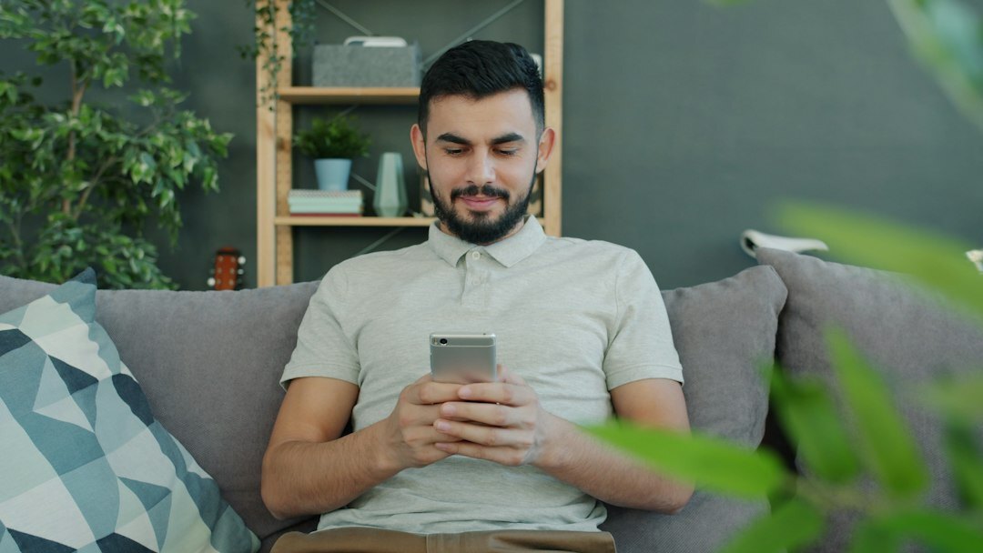 person scrolling smartphone at home